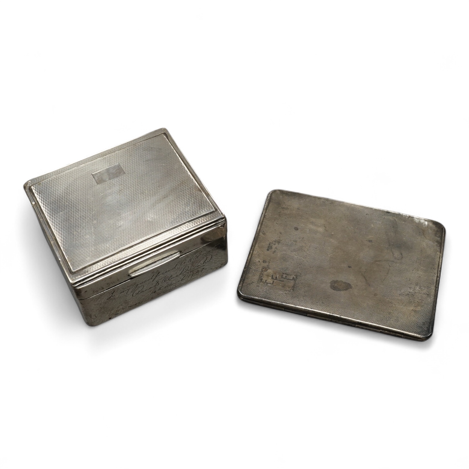 A 1930's engine turned silver cigarette case, 10.7cm and a similar part engine tuned silver cigarette box, with engraved inscription.